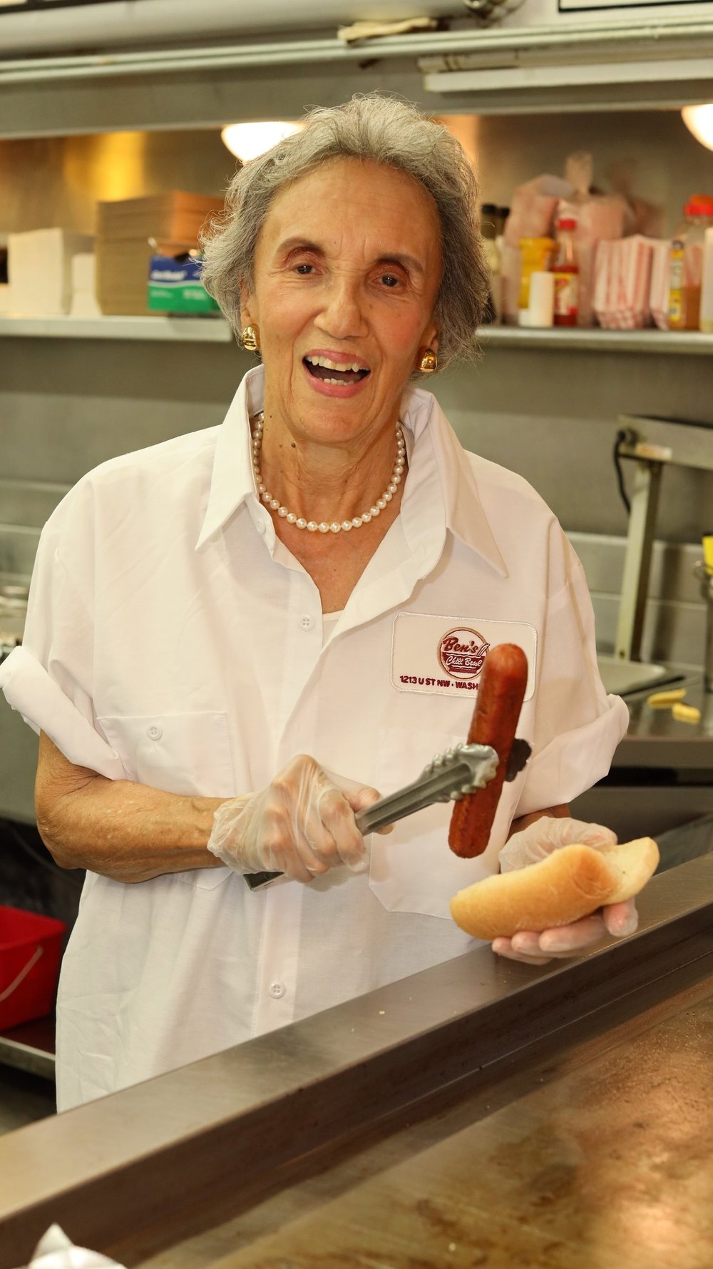 Woman making a hot dog